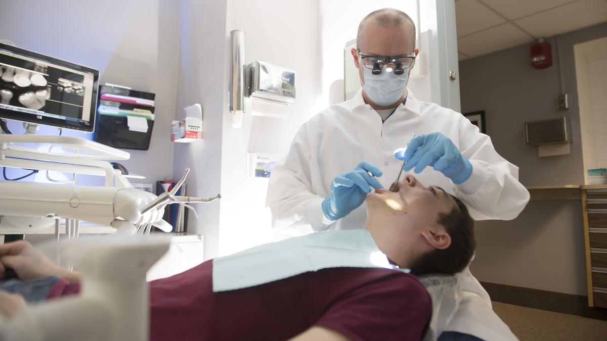 Dentist and adolescent patient